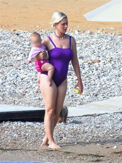 Katy Perry Stuns In Purple Swimsuit As She Hits The Beach With Fiancé