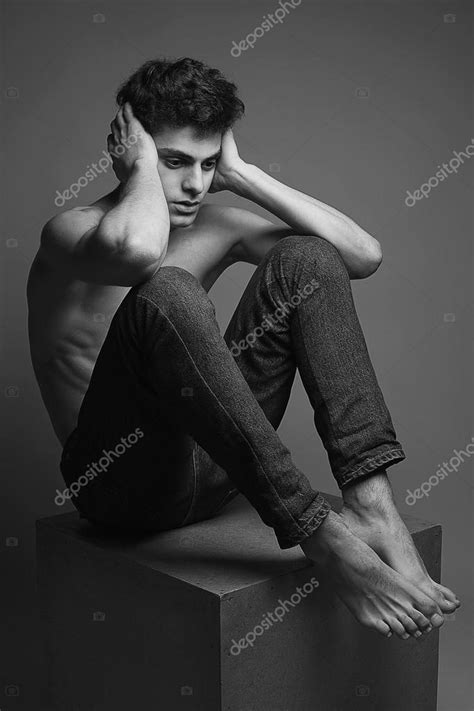 Handsome Muscular Male Model In Blue Jeans With Perfect Muscular