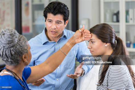 Confused Father Explains Teen Daughters Symptoms To Doctor High Res