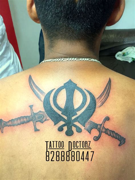 If you look close, you will notice that the symbol comprises three things, that is, a khandha in the middle, a chakra and two swords on both sides. #Khanda #Tattoo Make by Tattoo Doctorz Contact Us ...