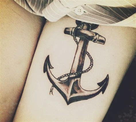 an anchor tattoo on the leg of a woman s thigh with rope around it