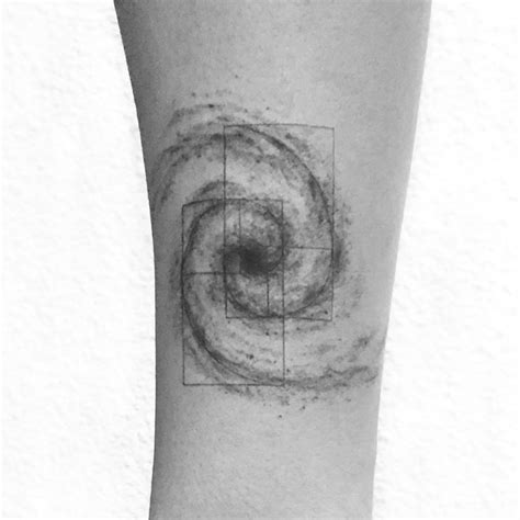 A Black And White Photo Of A Persons Arm With A Spiral Tattoo On It