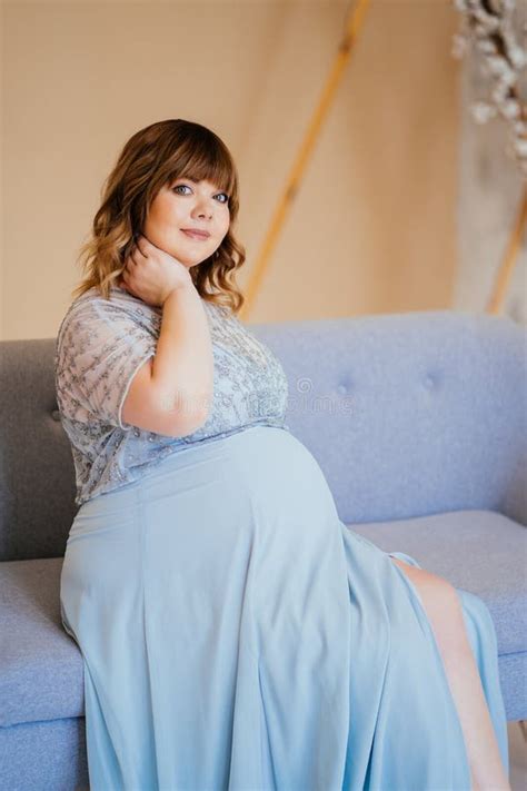 Pregnant With Overweight In Dress Sitting On Couch Stock Image Image
