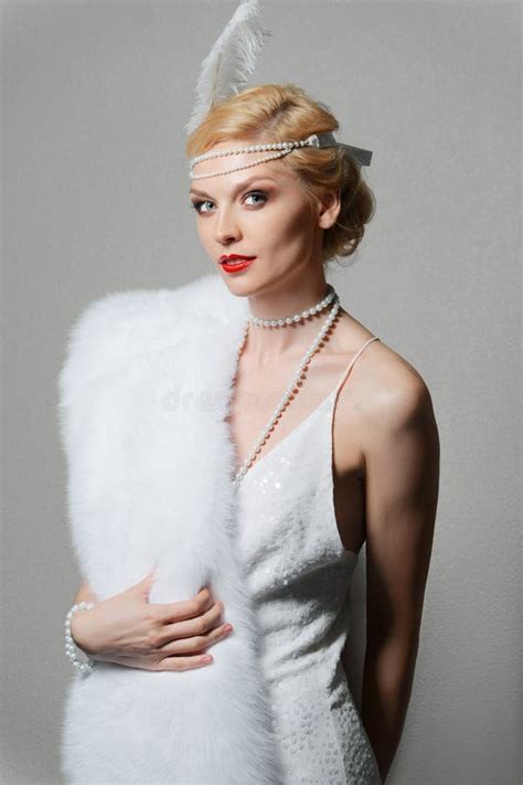Woman In White Dress With Shoulder Straps And Long Fur Stole Stock