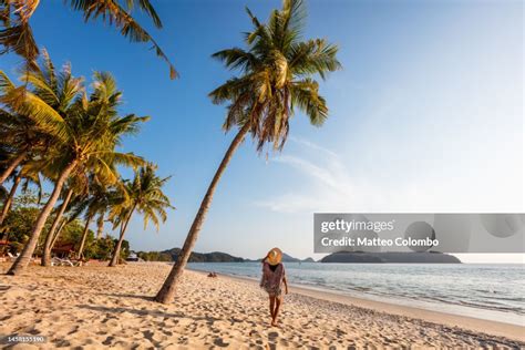 Woman At Pantai Cenang Beach At Sunset Langkawi Malaysia High Res Stock
