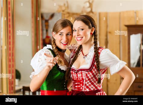 Young People In Traditional Bavarian Tracht In Restaurant Or Pub Stock