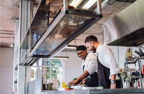 Chefs Cooking Together In Restaurant Kitchen Food Service Ace