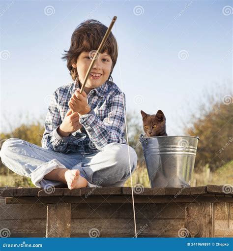 Happy Boy Go Fishing On The River With Pet One Children And Kitten Of