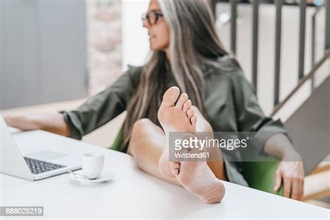 Woman Working In Office With Bare Feet On Desk Photo Getty Images
