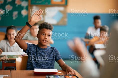Black Elementary Student Raising His Hand To Answer A Question During