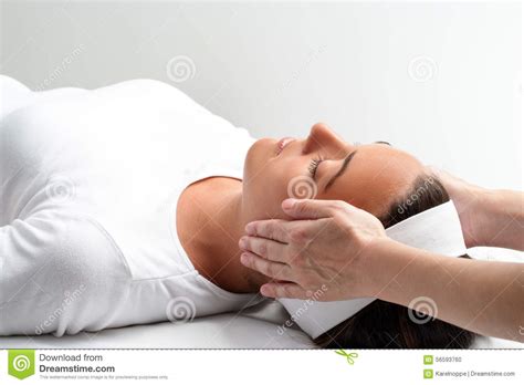 Therapist Doing Reiki With Hands Next To Womans Head Stock Photo