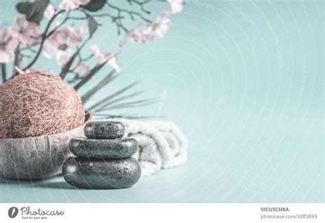 Zen Stones With Coco Nut And Towels At Light Blue Background With Flowers Relaxing Beauty Day