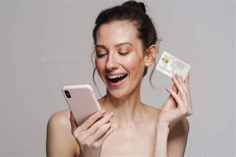 Excited Half Naked Woman Posing With Mobile Phone And Credit Card Stock