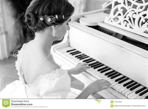 Beautiful Girl Playing The Piano In A Beautiful Dress In The Interior