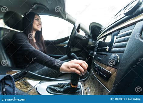 Young Woman Driver Shifting The Gear Stick And Driving A Car Stock