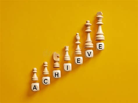 The Word Achieve On Wooden Cubes With Chess Pieces Goal Achievement