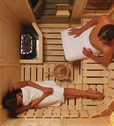 Two People In A Sauna With Towels On