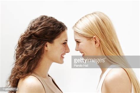 Portrait Of Two Young Women Smiling Side View High Res Stock Photo