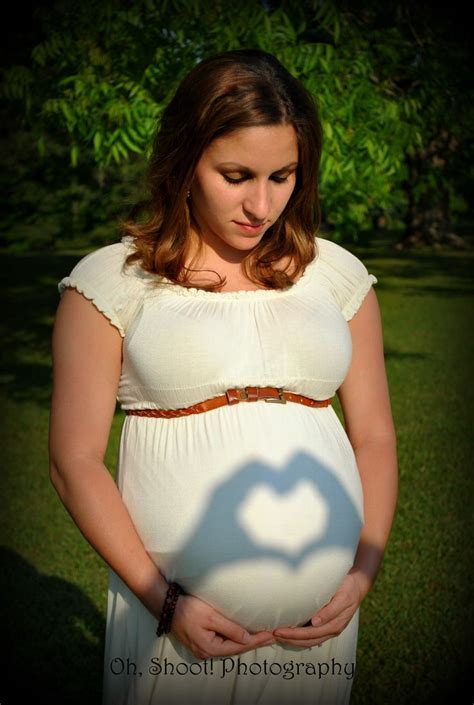 A Pregnant Woman Is Casting A Shadow On Her Belly