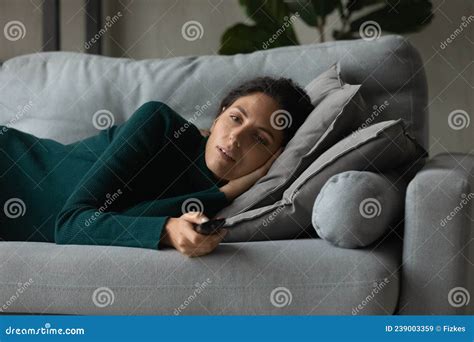 Lazy Happy Young Woman Getting Bored Watching Tv At Home Stock Image