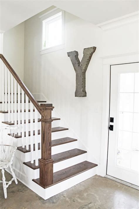 Farmhouse staircase features white oak railing and white oak crossed wood balusters and cable railing. Cool 80 Modern Farmhouse Staircase Decor Ideas https://livingmarch.com/80-modern-farmhouse ...