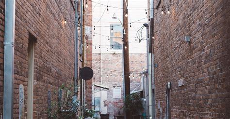Street Alley Between Brown Bricked Houses · Free Stock Photo