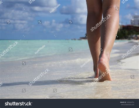Sexy Legs On Tropical Sand Beach With Footprints Walking Female Feet