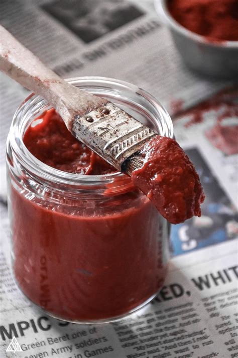 Low carb bbq sauce with a brush on newspaper with pot in bac. BEST Low Carb BBQ Sauce — Better Than the Real Deal!