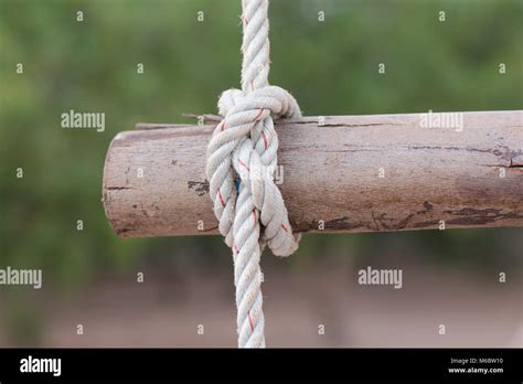 A Rope Is Tied In A Knot Around A Fence Post Rope Tied Knot Wood Pole