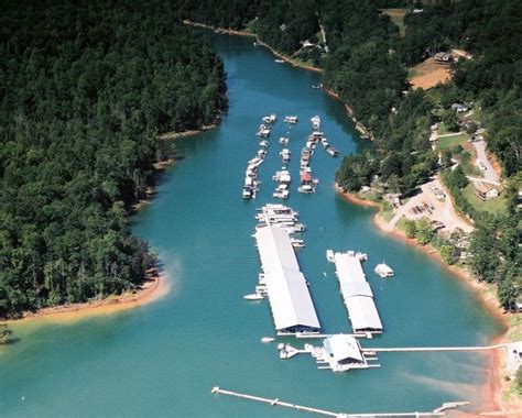 An Aerial View Of Several Boats Docked At A Dock In The Middle Of A Lake