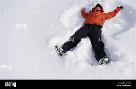 Boy Making Snow Angel Stock Photo Alamy