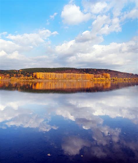 Beautiful Autumn Landscape With Reflections Of Clouds In Water And