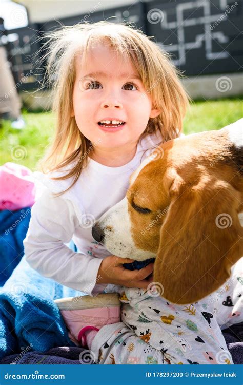 Child Playing With Beagle Dog Best Friend In Backyard On Sunny Spring