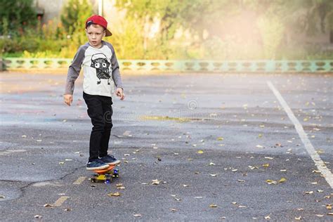 Little Urban Boy With A Penny Skateboard Young Kid Riding In Th Stock