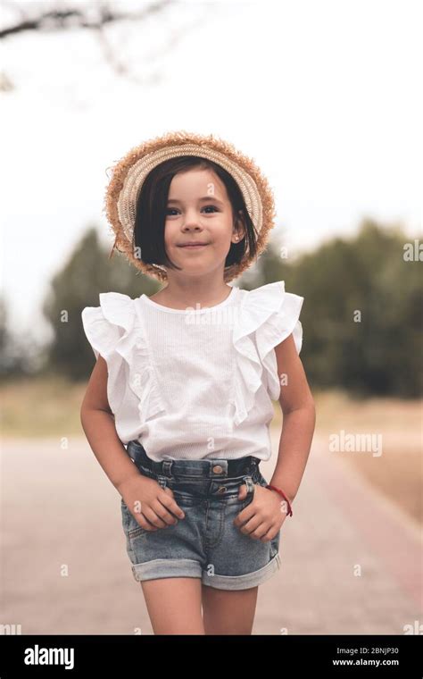Smiling Trendy Kid Girl 4 5 Year Old Wearing Straw Hat And Summer White
