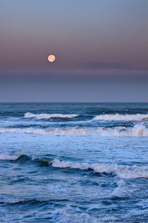 Cpleblow Full Moon Setting Off Of Ocean Beach Near Sunrise