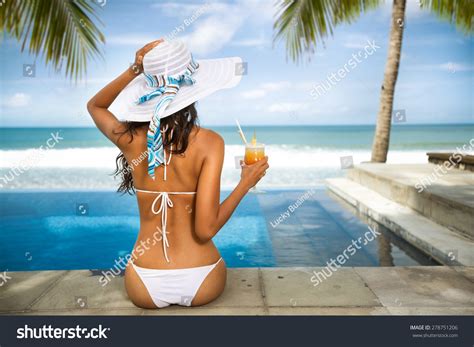 Sexy Woman In Bikini Enjoy In Tropical Resort Sitting Front Pool And Drinking Cocktail Back