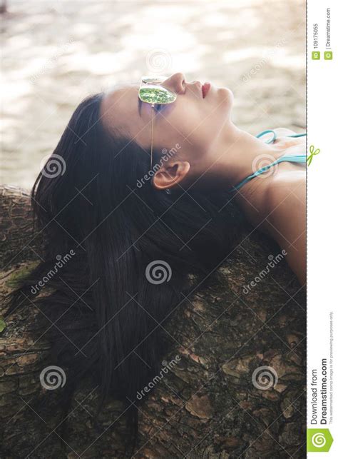 Relaxation Girl In A Sunglasses Blue Bikini Lies On The Tree Near The Sea Stock Image Image Of