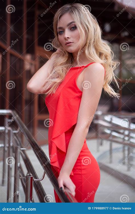 Een Mooi Sexy Blond Meisje In Een Rode Jurk Maakt Haar Chic Haar Op De