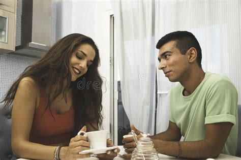 Beautiful Mixed Race Couple Drinking Coffee And Talking Stock Image