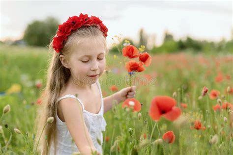 Ukrainian Beautiful Girl In Field Of Poppies And Wheat Outdoor