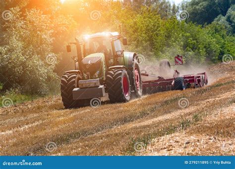 Modern Agricultural Tractor Is Cultivating Farm Land After Wheat