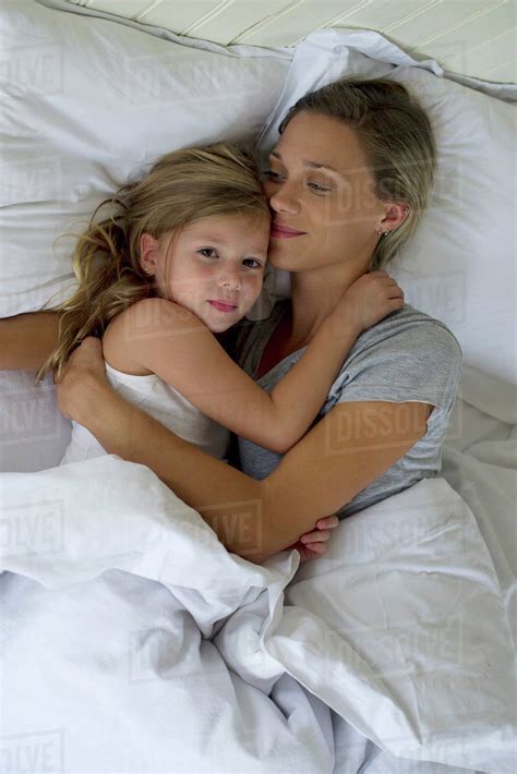 Mother And Daughter In Bed Embracing Stock Photo Dissolve
