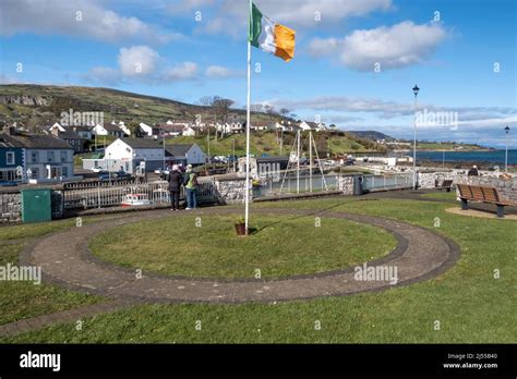 Irish Tricolour flying above the harbour at the North Antrim coastal
