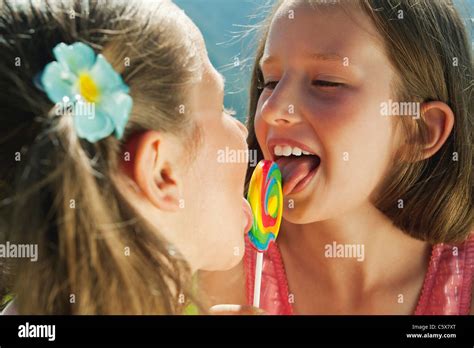 Italy South Tyrol Two Girls 6 7 10 11 Licking Lollypop Portrait