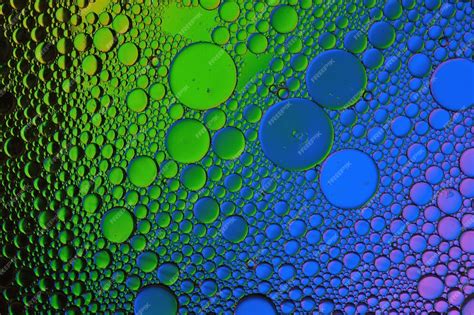 Premium Photo Background Of Colorful Oil Drops In Water Surface