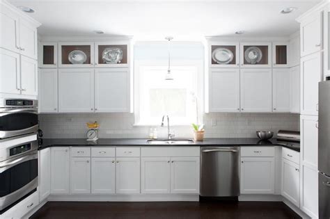 White cabinets, white counter, white subway tile (break up the white with wood cutting boards and other kitchen decor) as a kitchen specialist i will tell you this, any type of countertop can look good with cherry cabinets. White Kitchen Cabinets with Black Countertops ...