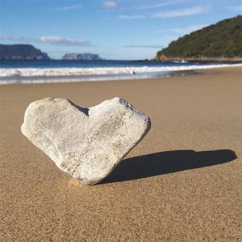 Heart Shaped Rock Sitting In Sand At Photograph By Jodie Griggs Pixels