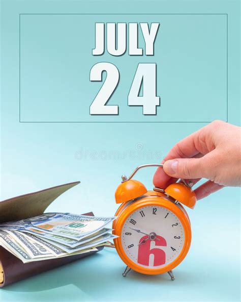 July 24th Hand Holding An Orange Alarm Clock A Wallet With Cash And A