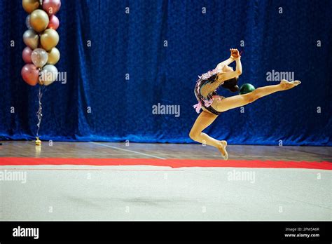 A Gymnast Girl Performs With A Hoop Flexible Athlete Performs A